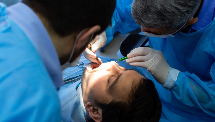 dentist and assistant during surgery at the dental clinic